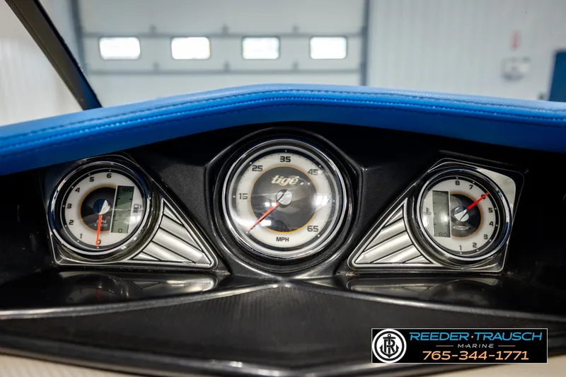 Slide: The Image of Dashboard of a 2013 Tigé RZR boat with speedometer and gauges. - 32