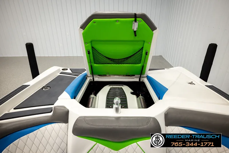 Slide: The Image of 2013 Tigé RZR boat engine compartment with vibrant green and blue interior accents. - 20