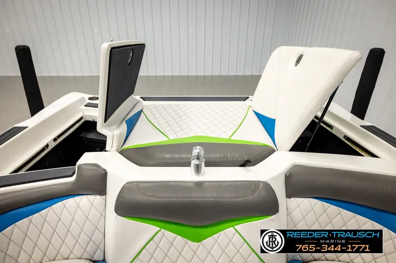 Slide: The Image of 2013 Tigé RZR boat interior with white, blue, and green upholstery details. - 24