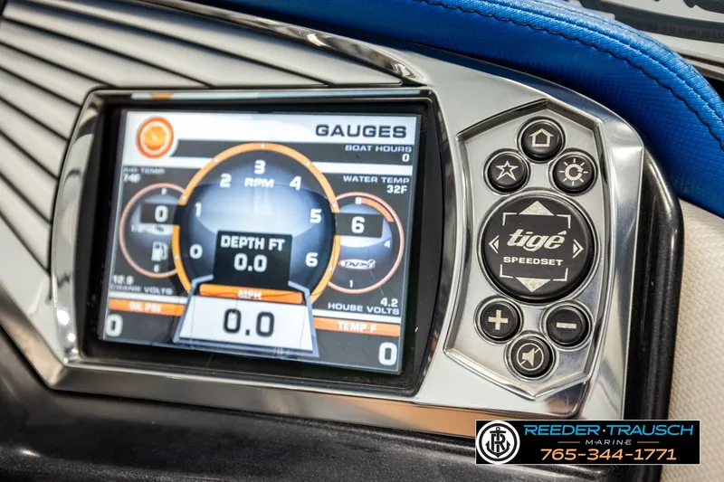 Slide: The Image of Close-up of 2013 Tigé RZR boat dashboard with digital gauges and control buttons. - 33