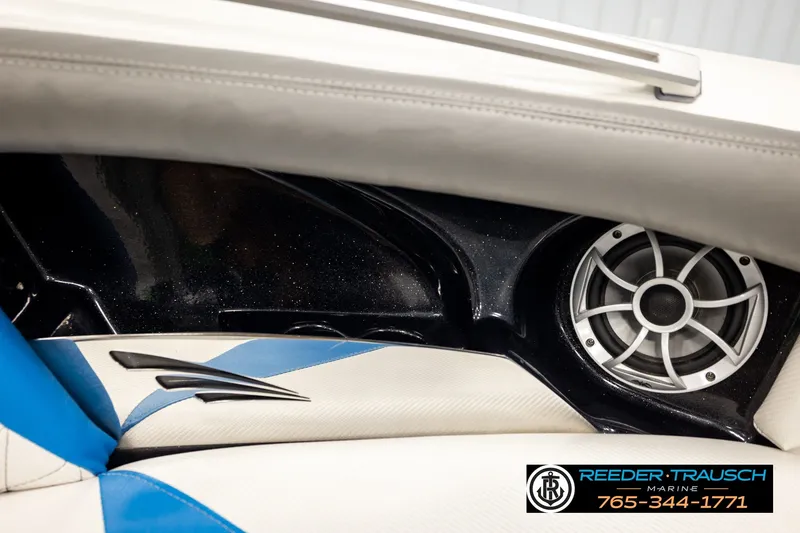 Slide: The Image of Interior of a 2013 Tigé RZR boat featuring a speaker and stylish upholstery. - 41