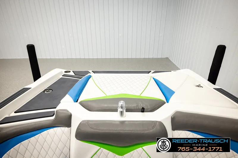 Slide: The Image of 2013 Tigé RZR boat interior with colorful upholstery and sleek design in a showroom. - 19