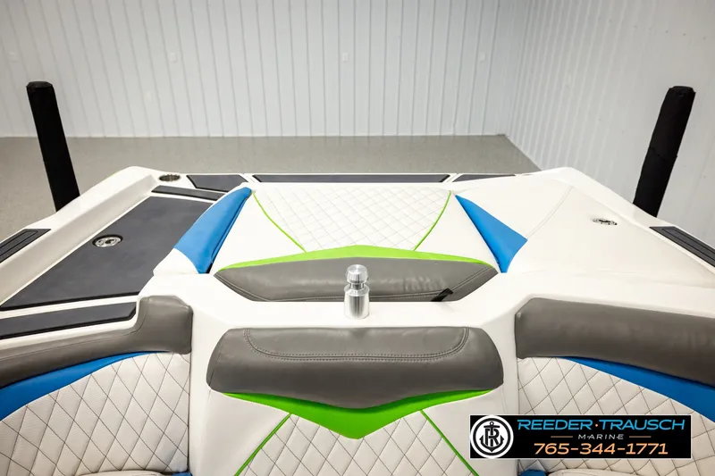Slide: The Image of 2013 Tigé RZR boat interior with blue, green, and white upholstery details. - 23