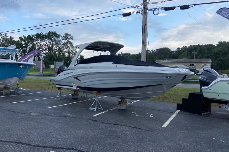 Slide: The Image of 2021 Crownline Eclipse E305 XS boat displayed outdoors on stands. - 7