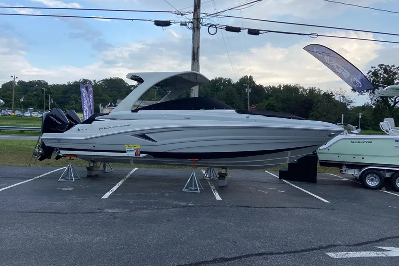 Slide: The Image of 2021 Crownline Eclipse E305 XS boat displayed outdoors on stands. - 6