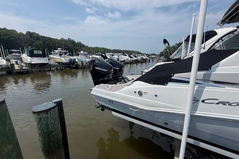 Slide: The Image of 2021 Crownline Eclipse E305 XS boat docked at marina with Mercury engine. - 3