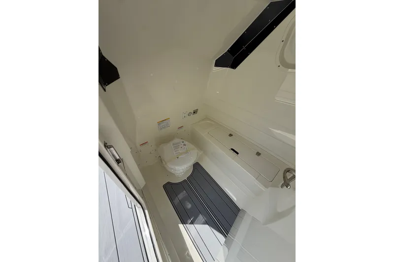 Slide: The Image of Interior of 2027 Brig Eagle 8 boat featuring a compact bathroom space. - 24