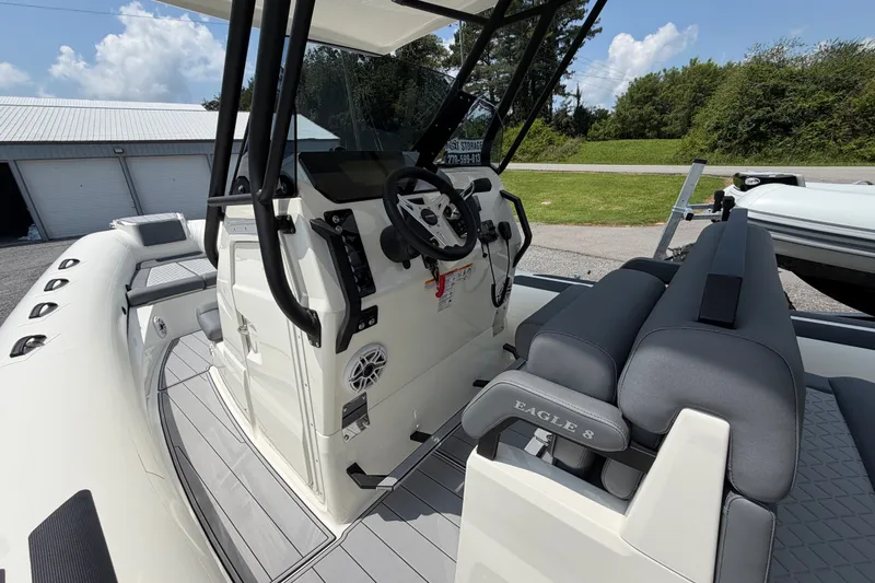 Slide: The Image of 2027 Brig Eagle 8 boat interior with modern helm and seating, showcasing sleek design. - 22