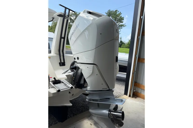 Slide: The Image of 2027 Brig Eagle 8 with Mercury outboard motor in a garage setting. - 34
