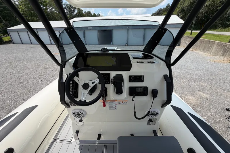 Slide: The Image of Cockpit of 2027 Brig Eagle 8 boat with steering wheel and navigation controls. - 21