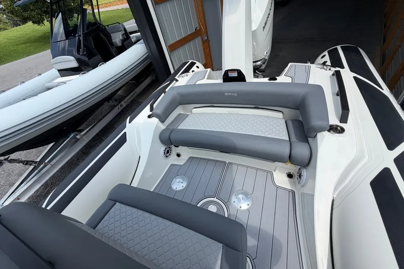 Slide: The Image of 2027 Brig Eagle 8 boat interior with gray seating and sleek design in a storage area. - 30