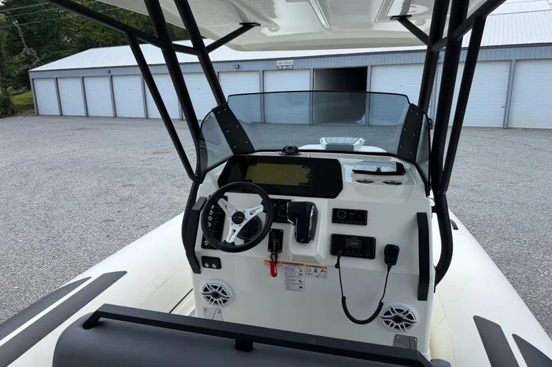 Slide: The Image of 2027 Brig Eagle 8 boat dashboard with steering wheel and navigation controls. - 31