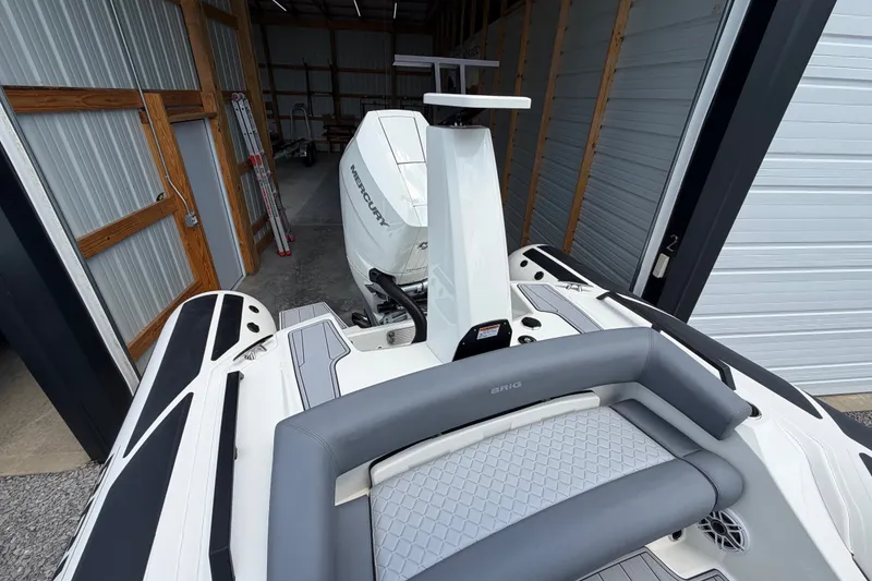 Slide: The Image of 2027 Brig Eagle 8 boat with Mercury engine in a storage facility. - 32