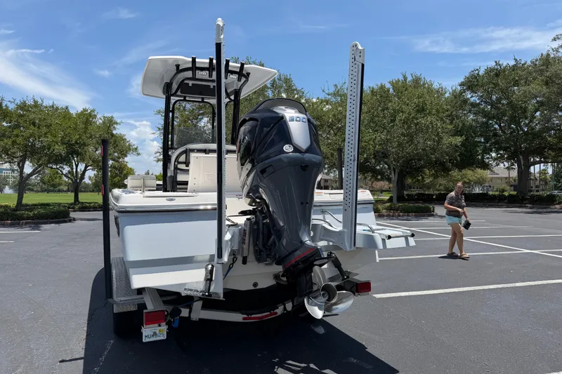 Slide: The Image of 2023 Robalo 226 Cayman boat with powerful outboard motor in a parking lot. - 4
