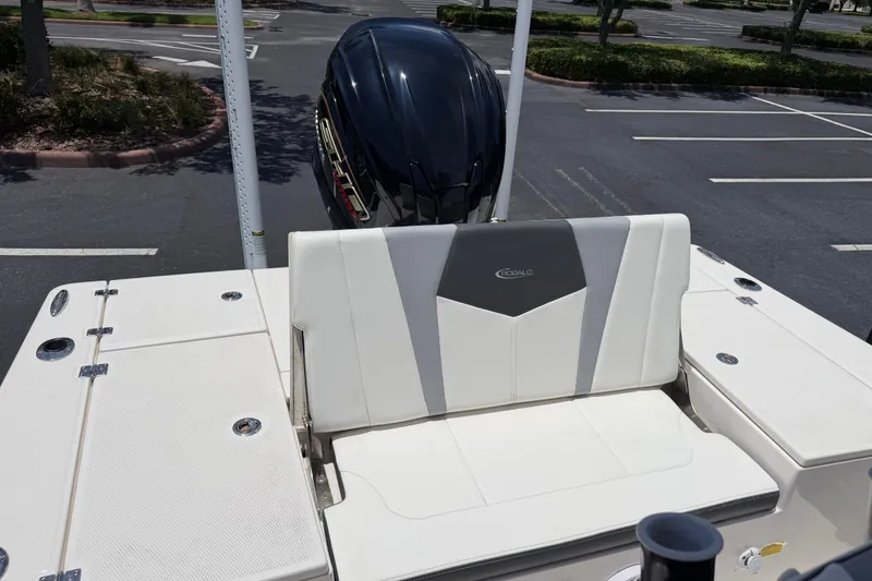 Slide: The Image of 2023 Robalo 226 Cayman boat with sleek seating and powerful outboard motor. - 14