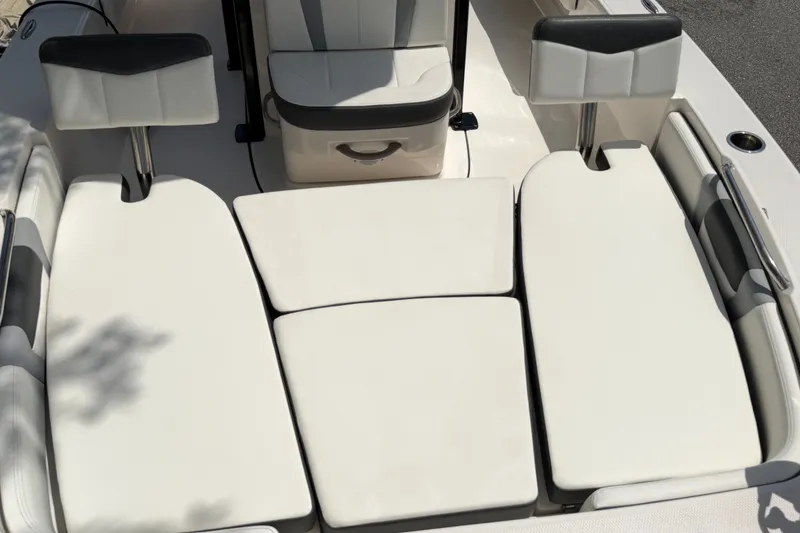 Slide: The Image of 2023 Robalo 226 Cayman boat interior with cushioned seating and sleek design. - 10