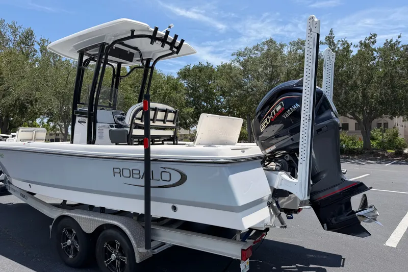Slide: The Image of 2023 Robalo 226 Cayman boat with Yamaha engine on trailer, parked outdoors. - 3