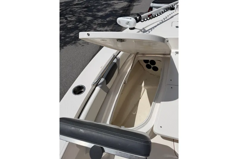 Slide: The Image of 2023 Robalo 226 Cayman boat storage compartment with open hatch, showcasing interior space. - 8