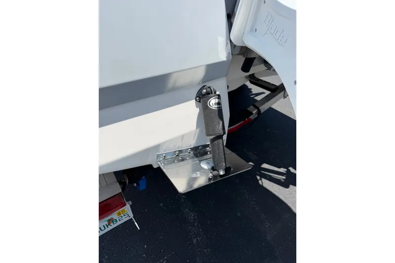 Slide: The Image of 2023 Robalo 226 Cayman boat trim tab detail in sunlight. - 17