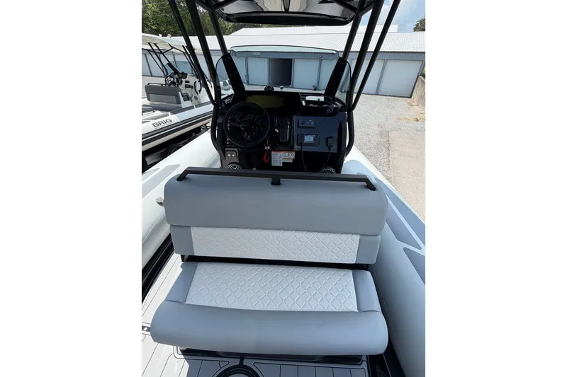 Slide: The Image of 2027 Brig Eagle 8 boat interior with modern dashboard and cushioned seating. - 27