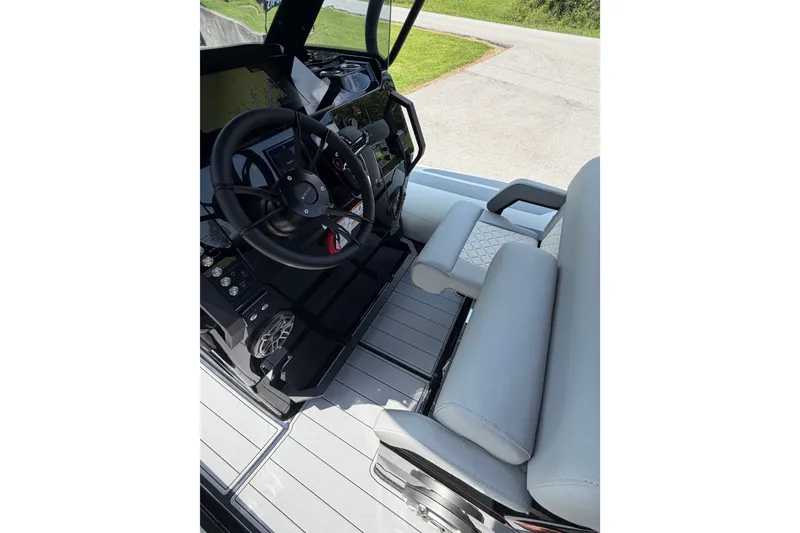Slide: The Image of 2027 Brig Eagle 8 boat cockpit with steering wheel and cushioned seating. - 15
