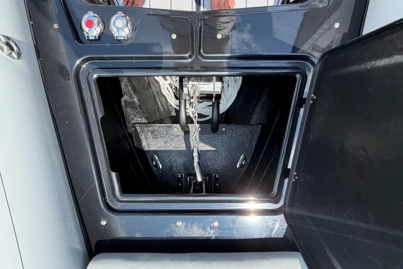 Slide: The Image of Anchor compartment of 2027 Brig Eagle 8 boat, featuring chain and controls. - 20