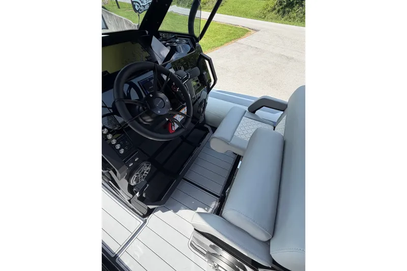 Slide: The Image of Interior view of 2027 Brig Eagle 8 boat, featuring steering wheel and seating area. - 14