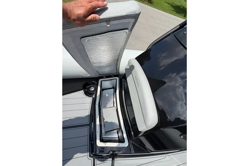 Slide: The Image of 2027 Brig Eagle 8 boat storage compartment with open hatch and cushioned seating. - 22
