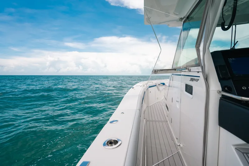 Slide: The Image of 2026 Formula 387 Center Console Fish boat cruising on open ocean under blue sky. - 66