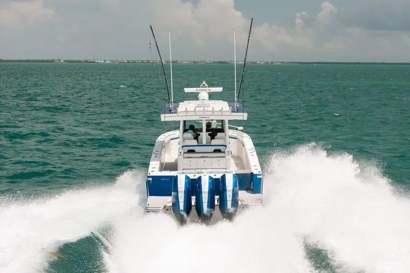 Slide: The Image of 2026 Formula 387 Center Console Fish boat speeding on open water. - 16