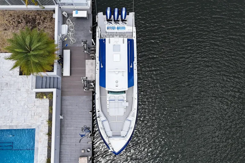 Slide: The Image of Overhead view of 2026 Formula 387 Center Console Sport boat docked by a waterfront deck. - 75