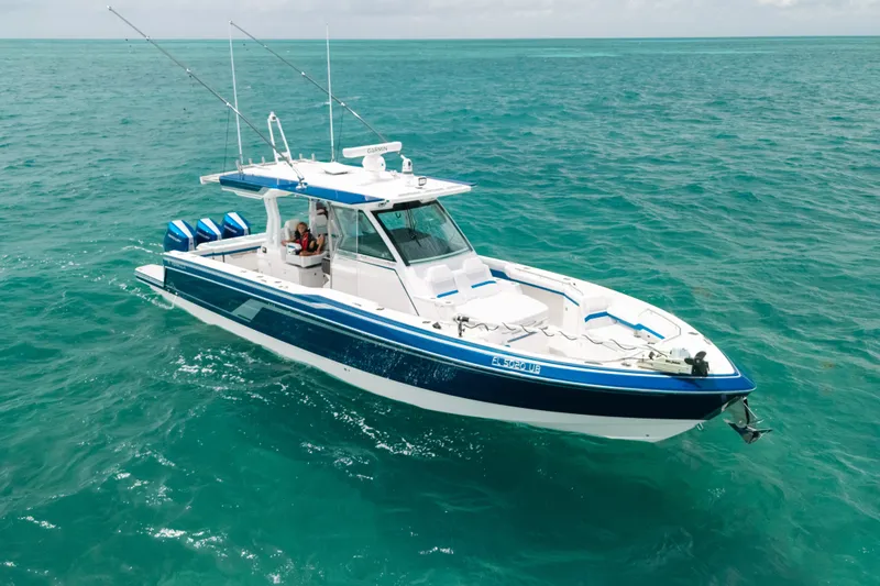 Slide: The Image of 2026 Formula 387 Center Console Fish boat cruising on clear blue ocean waters. - 12
