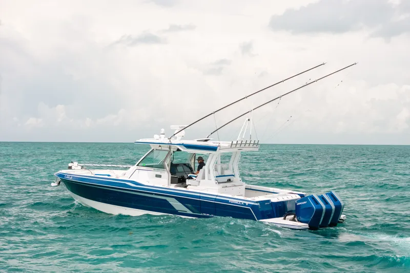 Slide: The Image of 2026 Formula 387 Center Console Fish boat cruising on open ocean waters. - 5