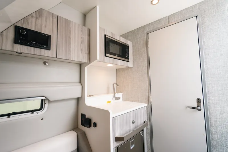 Slide: The Image of Interior of 2026 Formula 387 Center Console Fish with modern kitchenette and sleek design. - 70