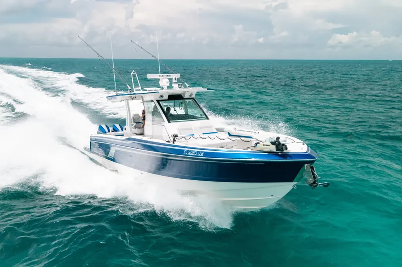 Slide: The Image of 2026 Formula 387 Center Console Fish boat cruising on open ocean waters. - 21