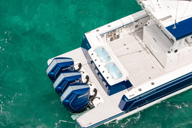 Slide: The Image of 2026 Formula 387 Center Console Fish boat with triple Mercury outboard engines on turquoise water. - 11