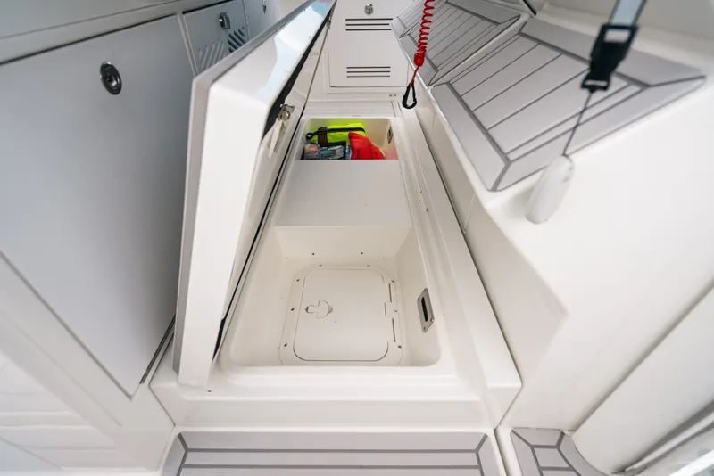 Slide: The Image of 2026 Formula 387 Center Console Fish boat storage compartment with open hatch and safety gear. - 49