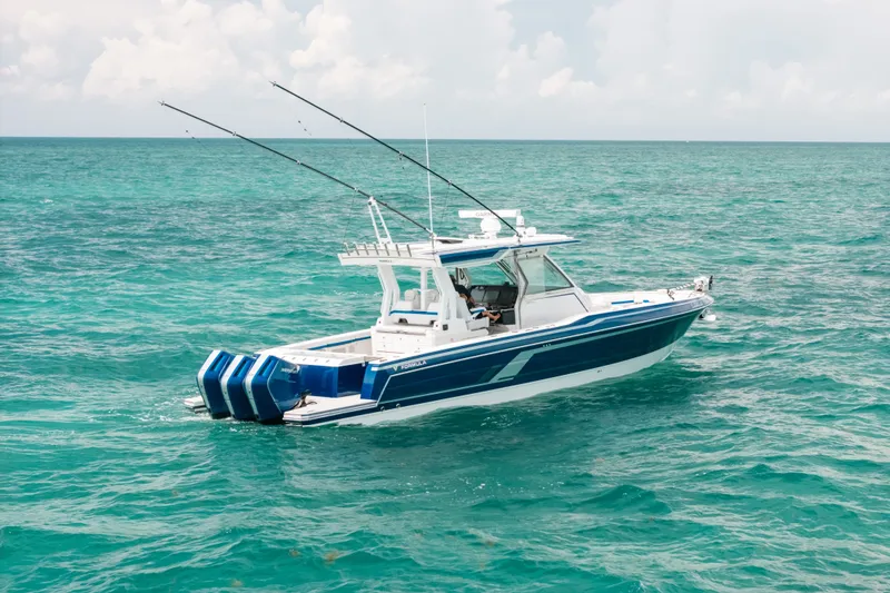 Slide: The Image of 2026 Formula 387 Center Console Fish boat on turquoise ocean waters. - 2
