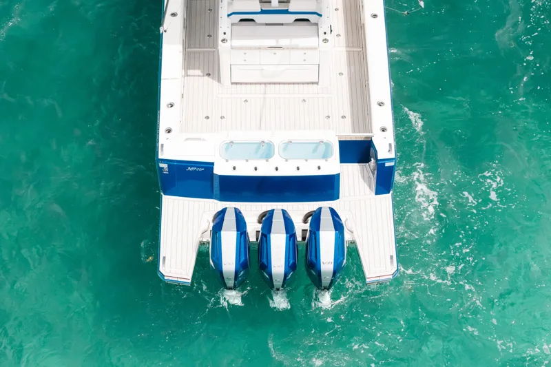 Slide: The Image of 2026 Formula 387 Center Console Fish boat with triple engines on turquoise water. - 20