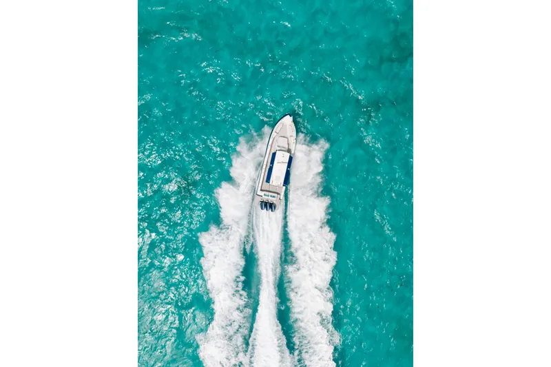 Slide: The Image of Aerial view of 2026 Formula 387 Center Console Fish boat cruising in turquoise waters. - 15