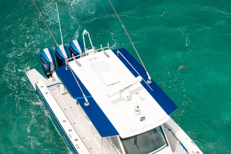 Slide: The Image of 2026 Formula 387 Center Console Fish boat on turquoise water, aerial view. - 7