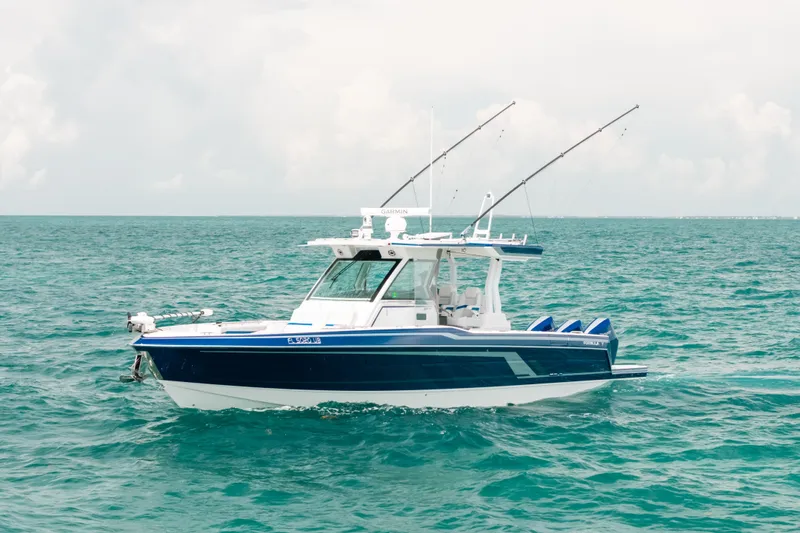 The Image of 2026 Formula 387 Center Console Fish boat on open sea, equipped for fishing. - 1