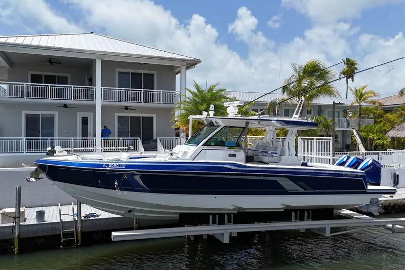 Slide: The Image of 2026 Formula 387 Center Console Sport boat docked near waterfront home. - 77