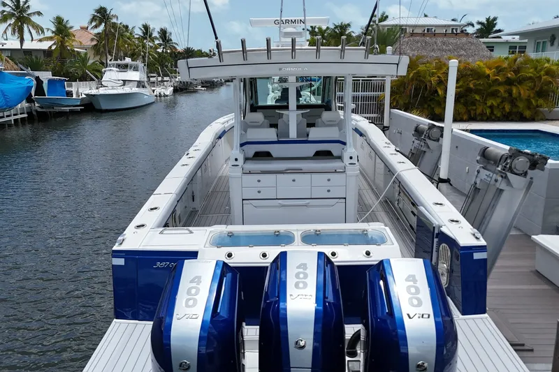 Slide: The Image of 2026 Formula 387 Center Console Sport boat with triple 400 V10 engines docked in a canal. - 76