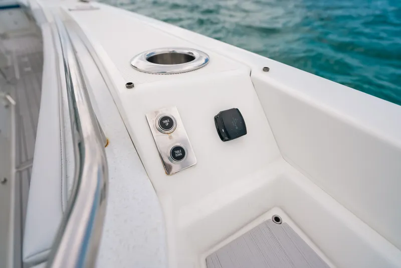 Slide: The Image of 2026 Formula 387 Center Console Fish boat interior with control buttons and cup holder. - 68