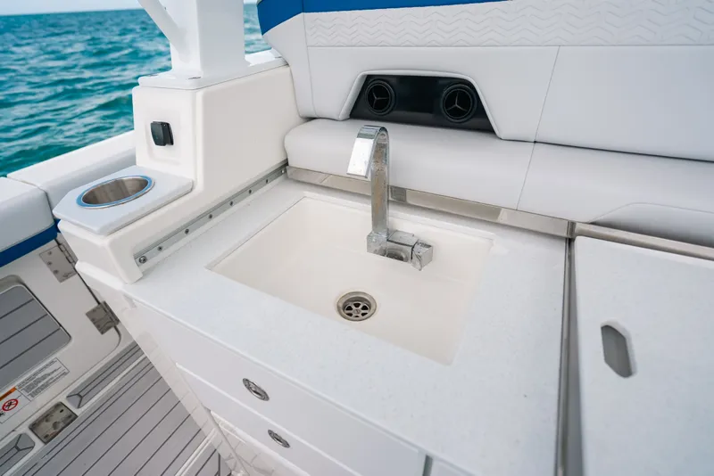 Slide: The Image of 2026 Formula 387 Center Console Fish boat interior with sink and seating area. - 44