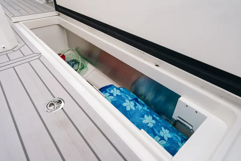 Slide: The Image of Storage compartment on 2026 Formula 387 Center Console Fish boat, featuring patterned cushions. - 47