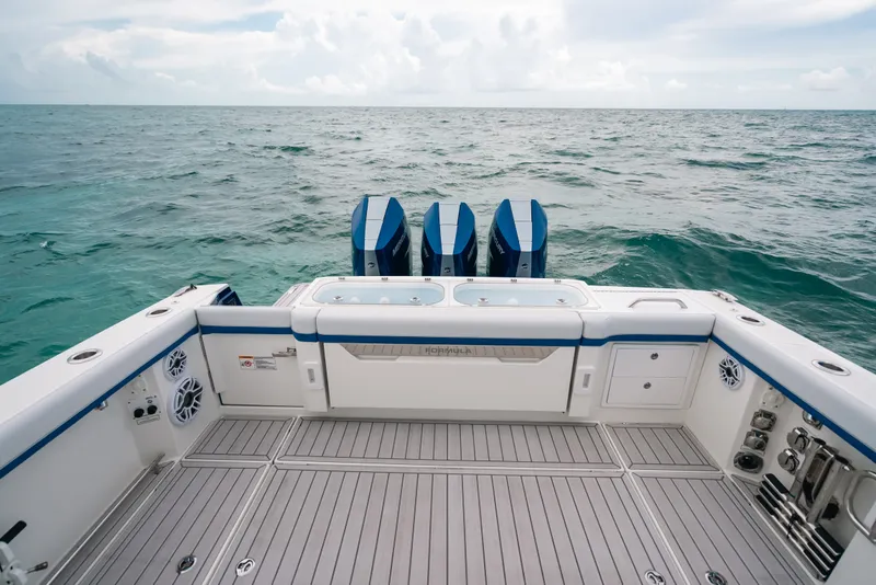 Slide: The Image of 2026 Formula 387 Center Console Fish boat with triple engines on open sea. - 58
