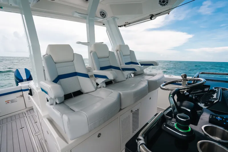 Slide: The Image of Luxury seating and helm of 2026 Formula 387 Center Console Fish boat on open sea. - 54