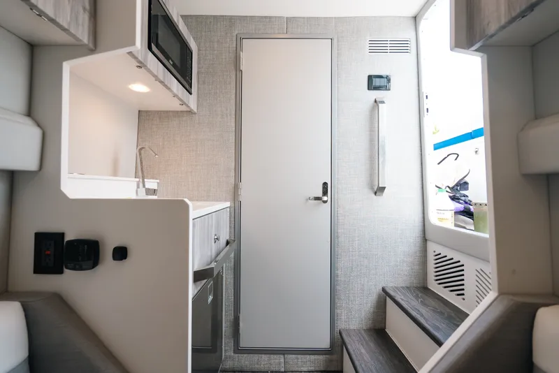 Slide: The Image of Interior of 2026 Formula 387 Center Console Fish boat, featuring modern kitchenette and sleek design. - 69